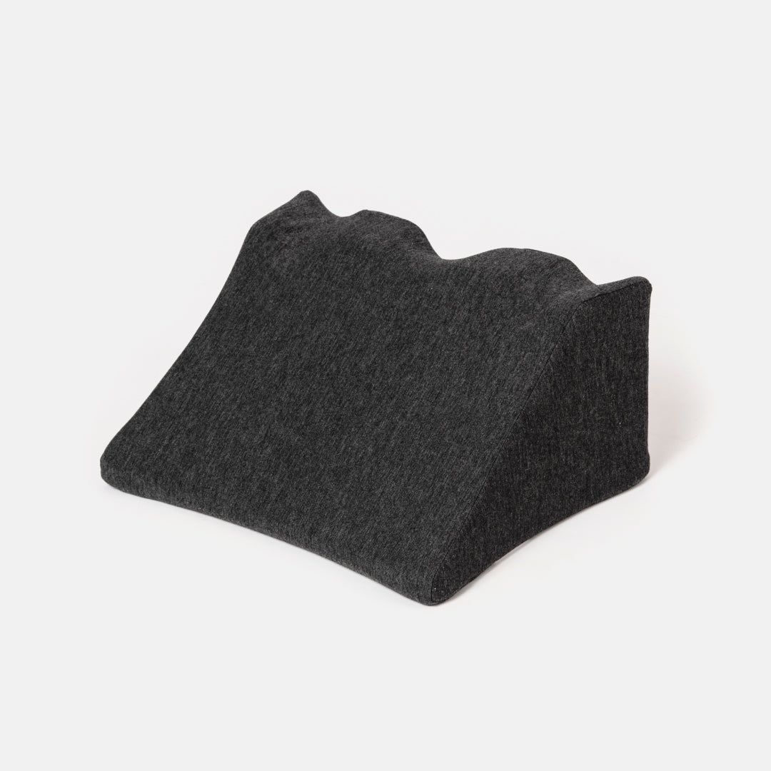 Black ergonomic cushion on a white background.